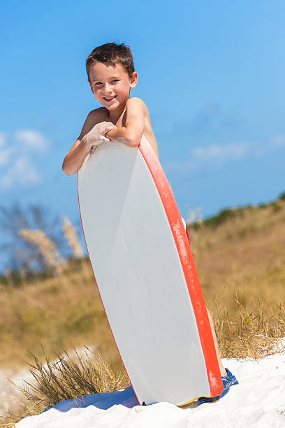 istock Boy Male Child on Beach With Surfboard 494712566