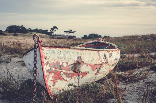 An old rowboat sits on a beach near Port Townsend, Washington USA.
