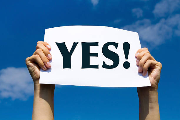 YES concept positive changes in the life, hands holding white sign on the sky background yes single word stock pictures, royalty-free photos & images