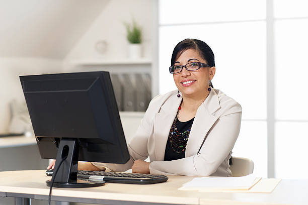 istock Latina Business Woman Sitting at Computer 494730442