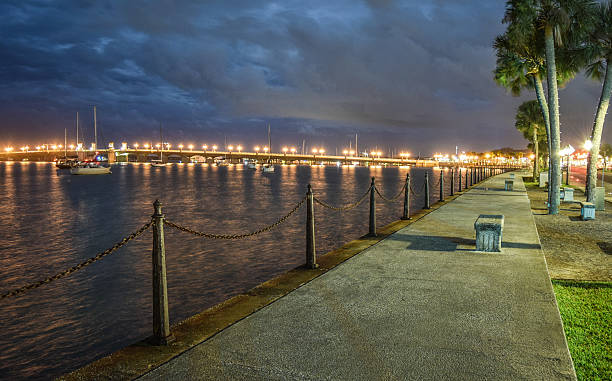 St. Augustine - Matanzas River at Night The walkway of the Matanzas River at Night with Bidge of Lions on St. Augustine, Florida. bridge of lions stock pictures, royalty-free photos & images