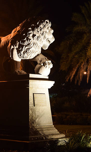Lion Statue Silhouette Lion monument at night guards the Bridge of Lions in St. Augustine, Florida. bridge of lions stock pictures, royalty-free photos & images