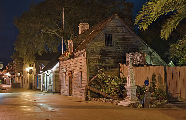 Old Schoolhouse in St. Augustine, Florida St. Augustine, Florida, USA - October 27, 2015: Oldest wooden schoolhouse in the United States, St. Augustine, Florida at night with empty street. schoolhouse stock pictures, royalty-free photos & images