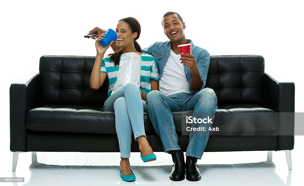 Couple on couch eating food and watching tv Couple on couch eating food and watching tvhttp://www.twodozendesign.info/i/1.png 20-24 Years Stock Photo