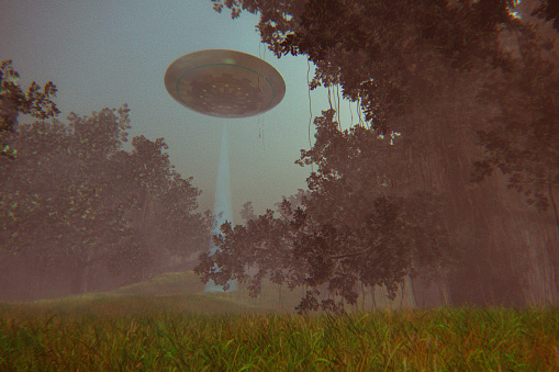 UFO flying over forest at night.