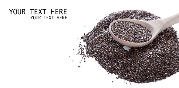 Dry chia seeds in spoon on white background