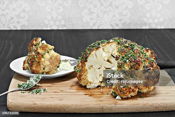 One Whole Roasted Cauliflower Head With A Slice Removed Stock Photo - Download Image Now