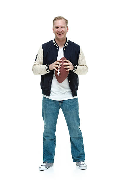 istock College student carrying a football 494733480