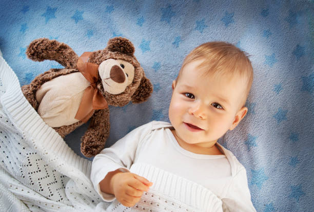 istock One year old baby with a teddy bear 494736278