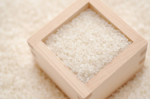 Japanese rice and masu (masu was a square wooden box used to measure rice in Japan, today are used for drinking sake). (shallow DOF)