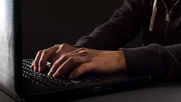 istock Man hacker typing on laptop keyboard at night 494737820