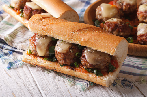 Tasty sandwich with meatballs and cheese close-up on the table. horizontal