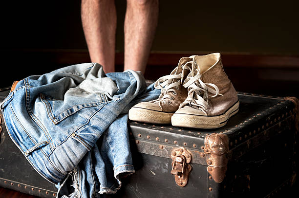 istock Pair of jeans and sneakers on suitcase 494738759