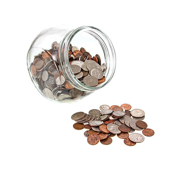 istock Wide mouth jar and spilled loose change 494739237