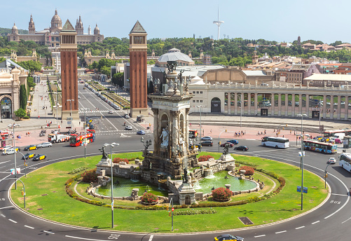 Barcelona, Spain - July 8, 2015: View top to The Placa d'Espanya in Barcelona. Placa d'Espanya fountain and the Fira de Barcelona conference center and Venetian Towers in the foreground, and the MNAC or National Palace and Torre Calatrava in the background, Barcelona, Spain.