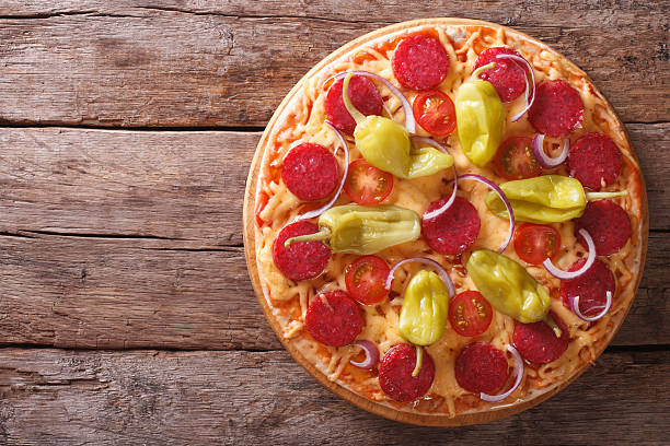 istock Italian pepperoni pizza closeup vertical top view , rustic 494739516