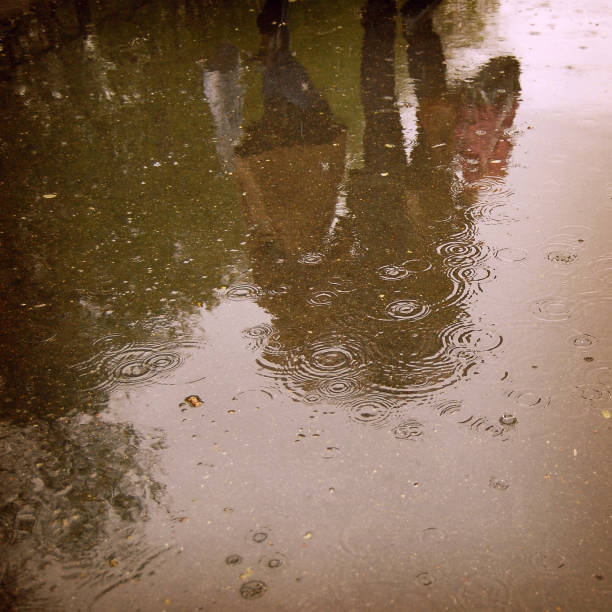 istock Walking people, reflection in the wet asphalt - vintage effect 494739577