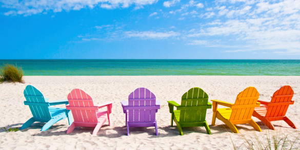 Adirondack Beach Chairs on a Sun Beach in front of a Holiday Vacation Travel house