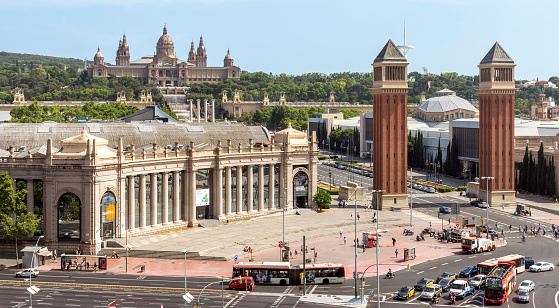 Barcelona, Spain - July 8, 2015: Fira Barcelona - a trade show and exhibition center in Barcelona, Spain. It was built in 1929 to International Exposition. People are walking by street.