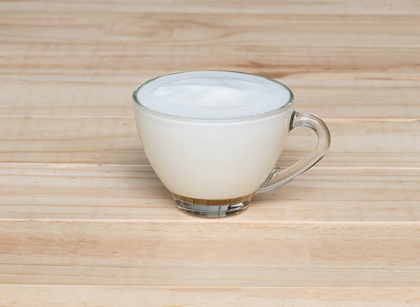 istock Hot milk on wood texture background 494753706