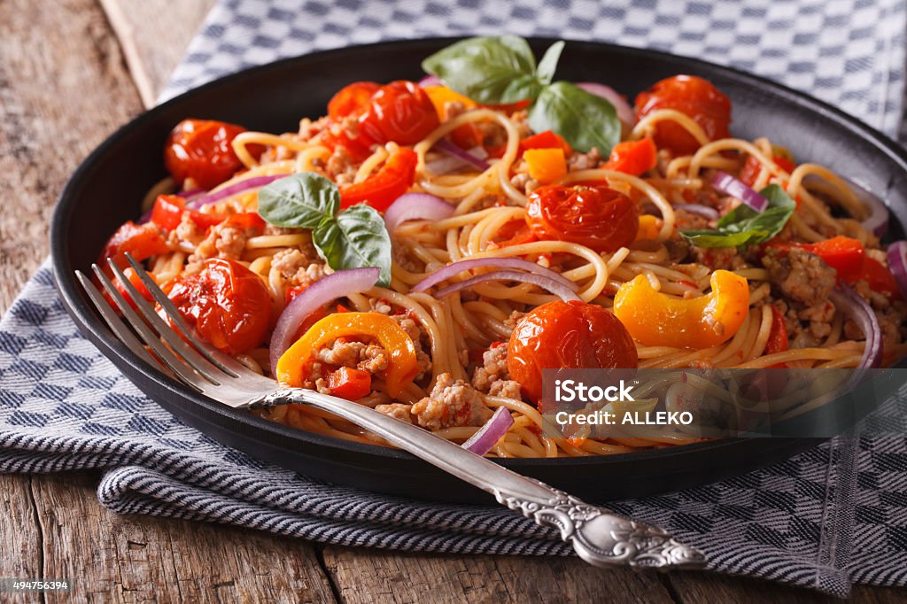 Pasta with minced meat and vegetables closeup horizontal Pasta with minced meat and vegetables close up in a black plate. Horizontal 2015 Stock Photo