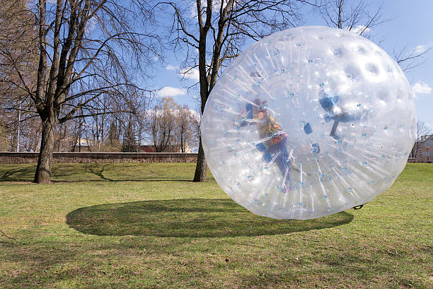 Zorbing Girl inside zorbing ball zorb ball stock pictures, royalty-free photos & images
