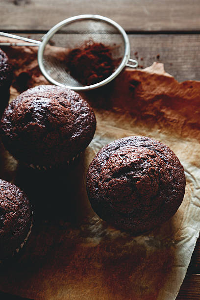 istock chocolate muffin on wooden table 494761304