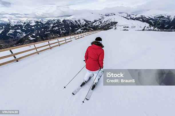 Back View Of A Skier Skiing On A Mountain Stock Photo - Download Image Now - 2015, Activity, Adult