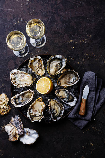 istock Opened Oysters Speciale de Claire and white wine 494761750