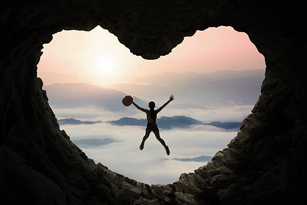 istock Woman leaps inside cave at mountain 494761766