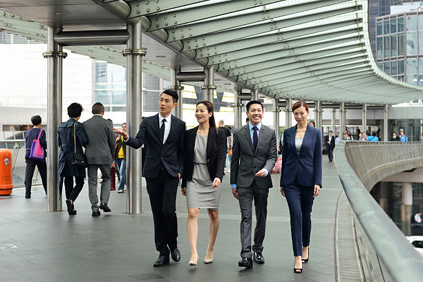 istock 4 people walking in Hong Kong financial district 494761881