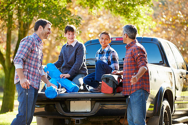 istock Fathers With Sons Unpacking Truck On Camping Holiday 494761937