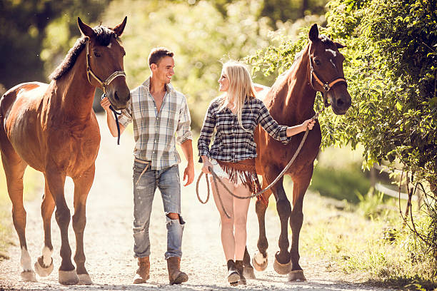 istock Smiling couple walking with horses and talking. 494762176