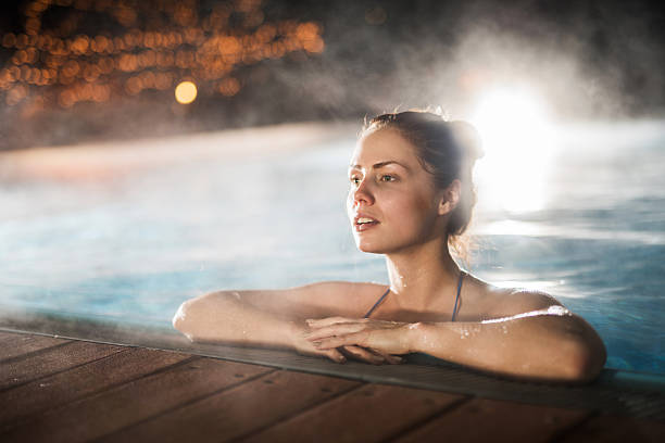 istock Woman spending a winter night in a heated swimming pool. 494762284
