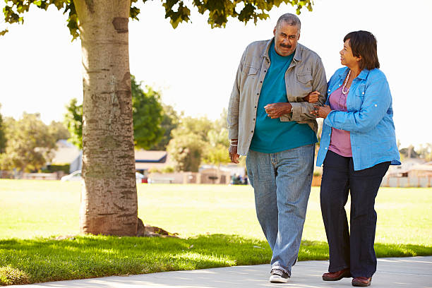 istock Senior Couple Walking In Park Together 494762333