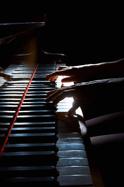 istock Woman's hands on the keyboard of the piano in night 494762514