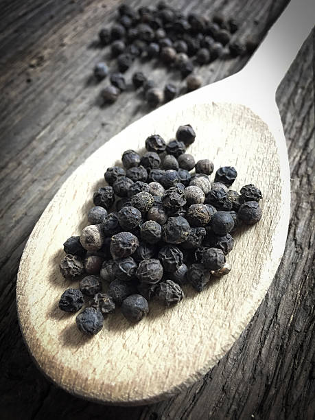 istock Fine served black peppercorns on wooden background 494763632