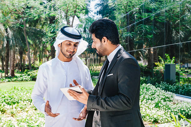 istock Two arab business people working with digital tablet at city 494763686