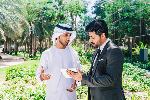 istock Two arab business people working with digital tablet at city 494763908