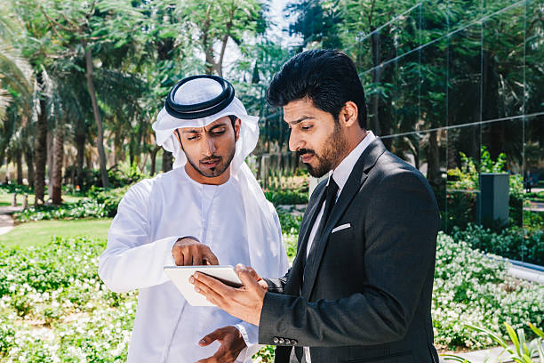 istock Two arab business people working with digital tablet at city 494763990