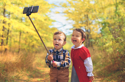 two little kids taking selfie