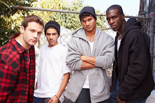 istock Group Of Young Men In Urban Setting Standing By Fence 494764811
