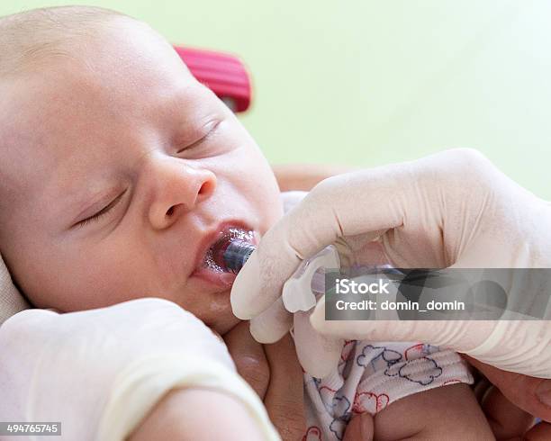 Vaccination Little Baby In Doctors Clinic Nurse Giving Vaccine Orally Stock Photo - Download Image Now