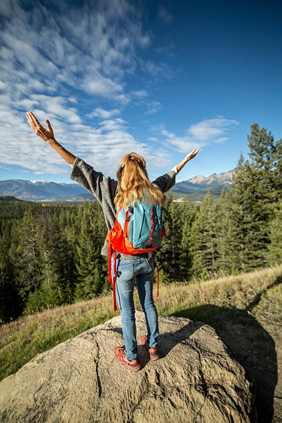 istock Cheering woman at mountain top celebrating 494766596