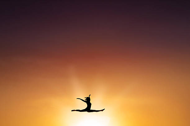 istock Female dancer leap on the air at sunset time 494766986