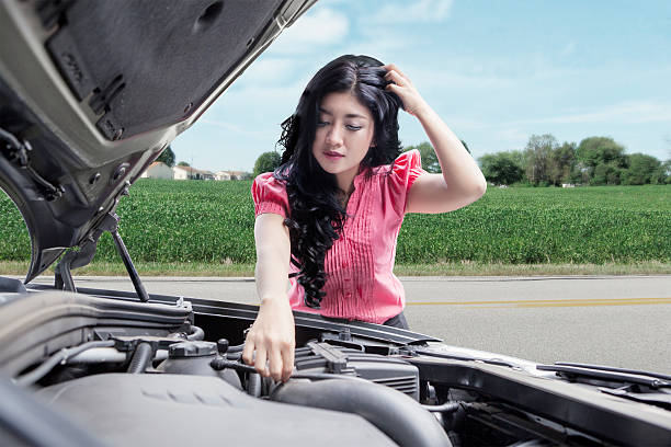 istock Frustrated woman repairing broken car 494767210