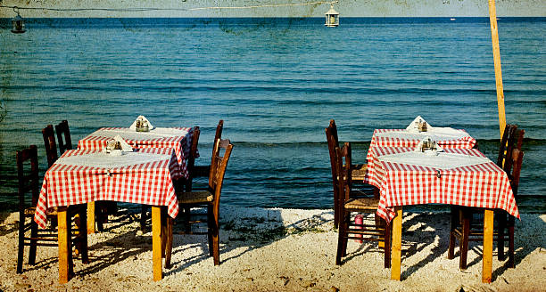 istock Greek specific - dining table and chairs on the beach 494768291