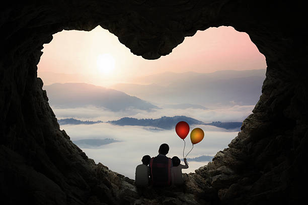 istock Father and children enjoy mountain view in cave 494768408