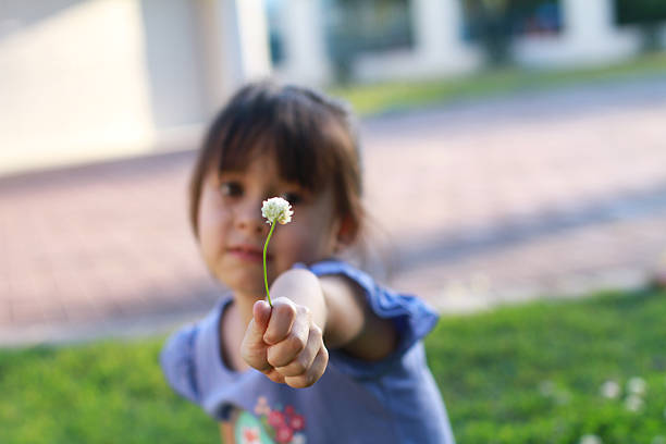 istock Girl holding clover flower 494780227