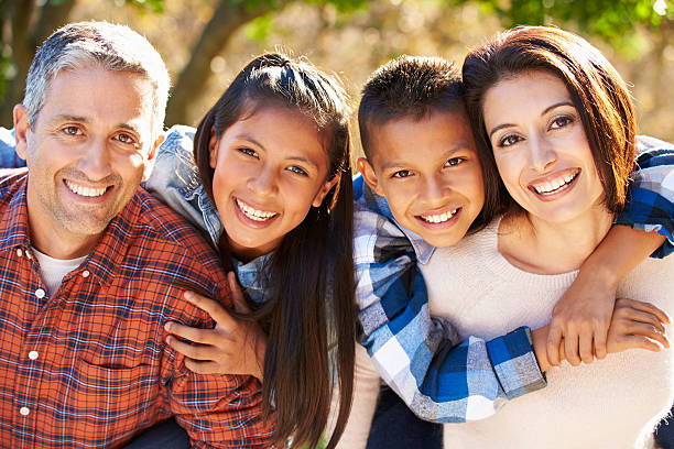 famiglia ispanica felice all'aria aperta nel paese - family with two children father clothing smiling foto e immagini stock